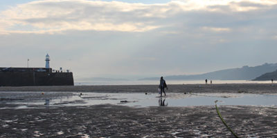 People walking on Harbour Beach in St Ives