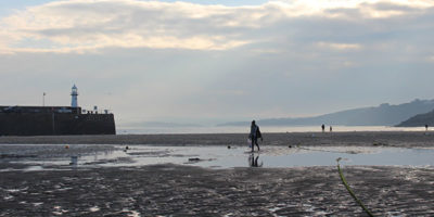 People walking on Harbour Beach in St Ives