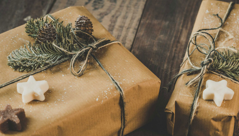 wrapped christmas presents on wooden table