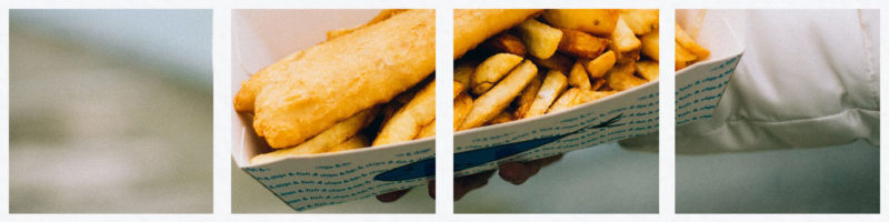 fish and chips in a box by the sea