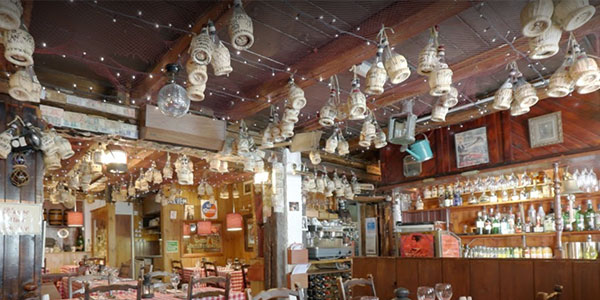Bottles and lights hang from beams in the Mermaid restaurant St Ives